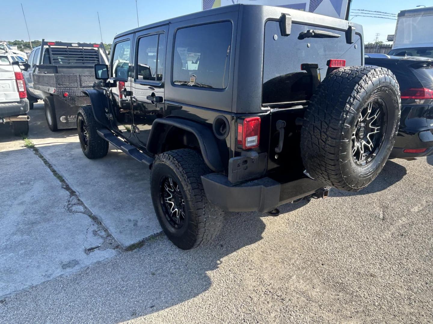 2016 Black Jeep Wrangler Unlimited Sahara 4WD (1C4HJWEG8GL) with an 3.6L V6 DOHC 24V FFV engine, located at 1687 Business 35 S, New Braunfels, TX, 78130, (830) 625-7159, 29.655487, -98.051491 - Photo#2