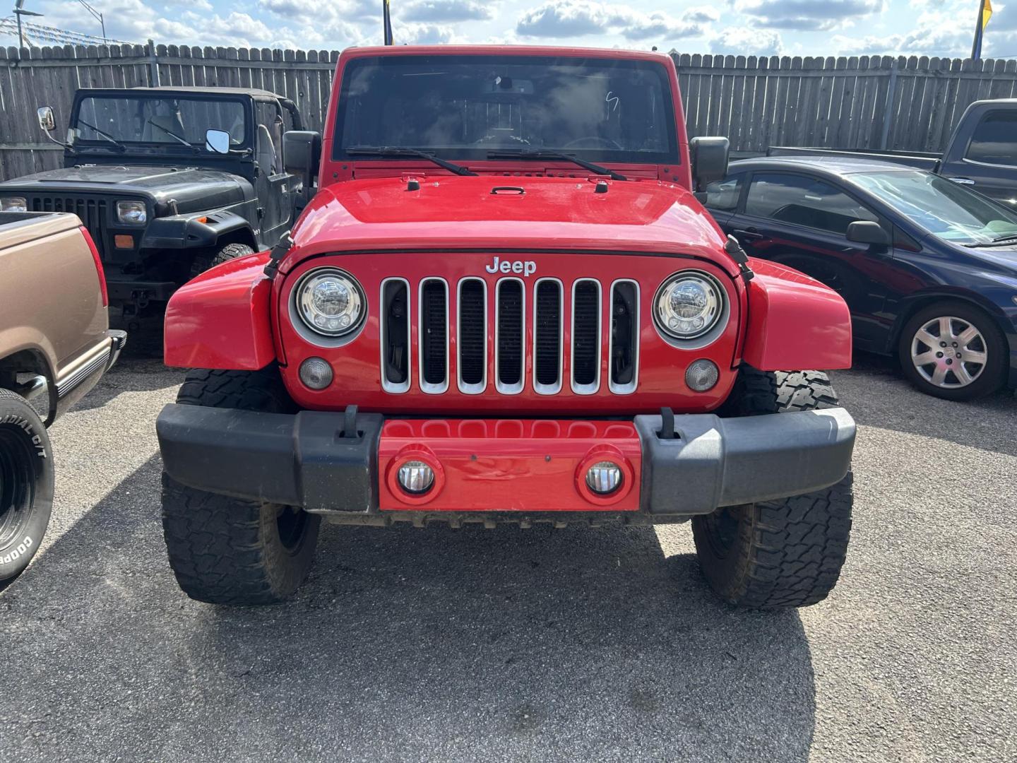 2017 Red Jeep Wrangler Unlimited Sahara 4WD (1C4HJWEGXHL) with an 3.6L V6 DOHC 24V FFV engine, located at 1687 Business 35 S, New Braunfels, TX, 78130, (830) 625-7159, 29.655487, -98.051491 - Photo#1