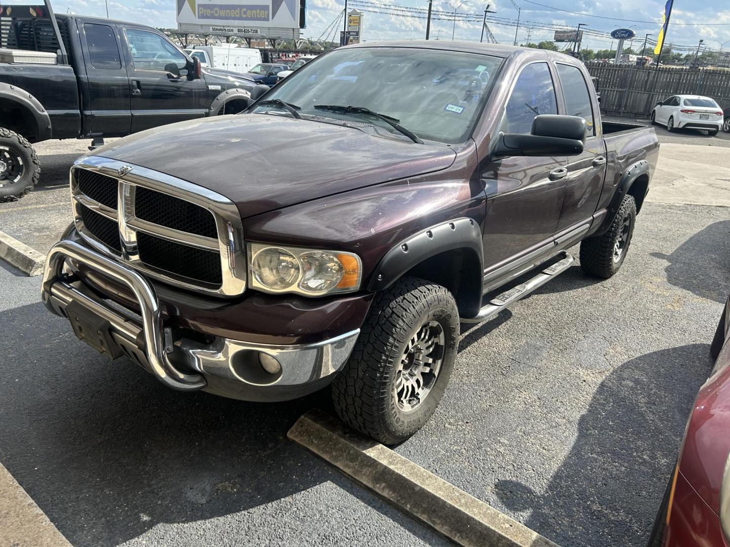 2004 Maroon Dodge Ram 2500 Laramie Quad Cab 4WD (3D7KU28C74G) with an 5.9L L6 OHV 24V TURBO DIESEL engine, located at 1687 Business 35 S, New Braunfels, TX, 78130, (830) 625-7159, 29.655487, -98.051491 - Photo#0