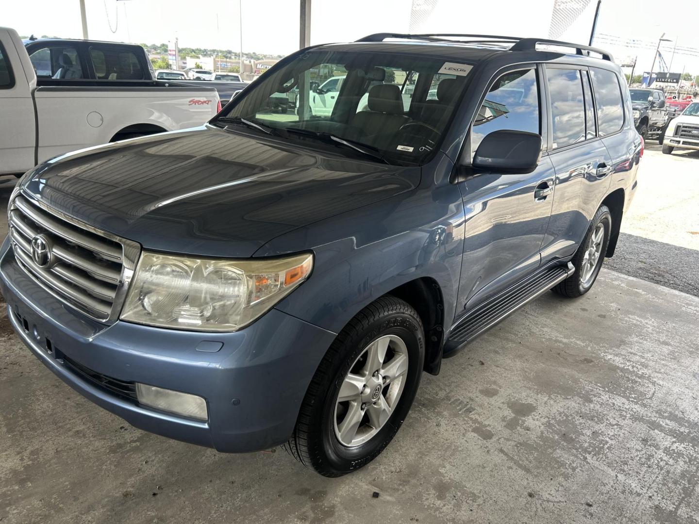 2010 Blue /Tan Toyota Land Cruiser 4WD (JTMHY7AJ0A5) with an 5.7L V8 DOHC 32V engine, 6-Speed Automatic transmission, located at 1687 Business 35 S, New Braunfels, TX, 78130, (830) 625-7159, 29.655487, -98.051491 - Photo#0