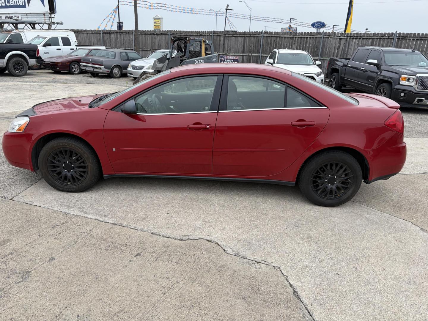 2006 Red Pontiac G6 V6 Sedan (1G2ZG558164) with an 3.5L V6 OHV 12V engine, 4-Speed Automatic Overdrive transmission, located at 1687 Business 35 S, New Braunfels, TX, 78130, (830) 625-7159, 29.655487, -98.051491 - Photo#1