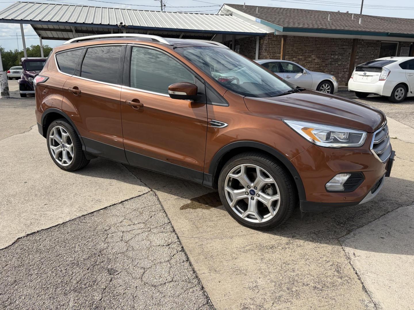 2017 Copper Ford Escape Titanium FWD (1FMCU0J9XHU) with an 2.0L L4 DOHC 16V engine, 6A transmission, located at 1687 Business 35 S, New Braunfels, TX, 78130, (830) 625-7159, 29.655487, -98.051491 - Photo#1