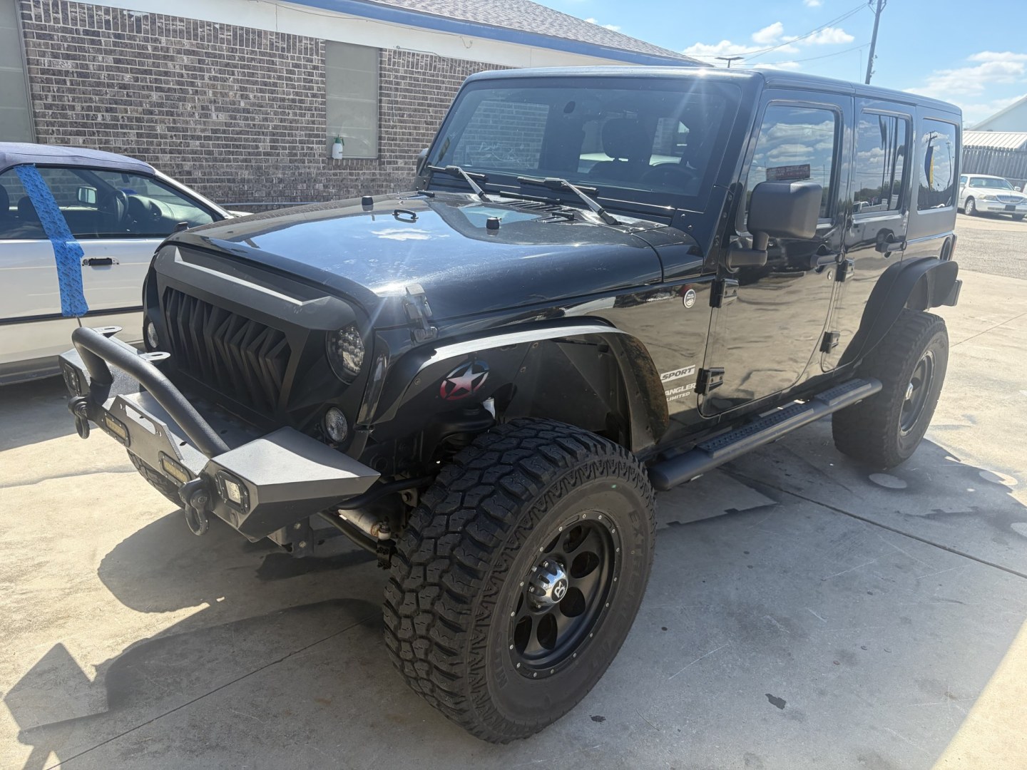 2014 Black Jeep Wrangler Unlimited Sport 4WD (1C4BJWDG5EL) with an 3.6L V6 DOHC 24V FFV engine, located at 1687 Business 35 S, New Braunfels, TX, 78130, (830) 625-7159, 29.655487, -98.051491- Photo#0