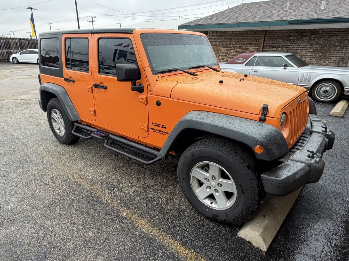 2012 Orange Jeep Wrangler Unlimited Sport 4WD (1C4BJWDGXCL) with an 3.6L V6 DOHC 24V FFV engine, located at 1687 Business 35 S, New Braunfels, TX, 78130, (830) 625-7159, 29.655487, -98.051491- Photo#1