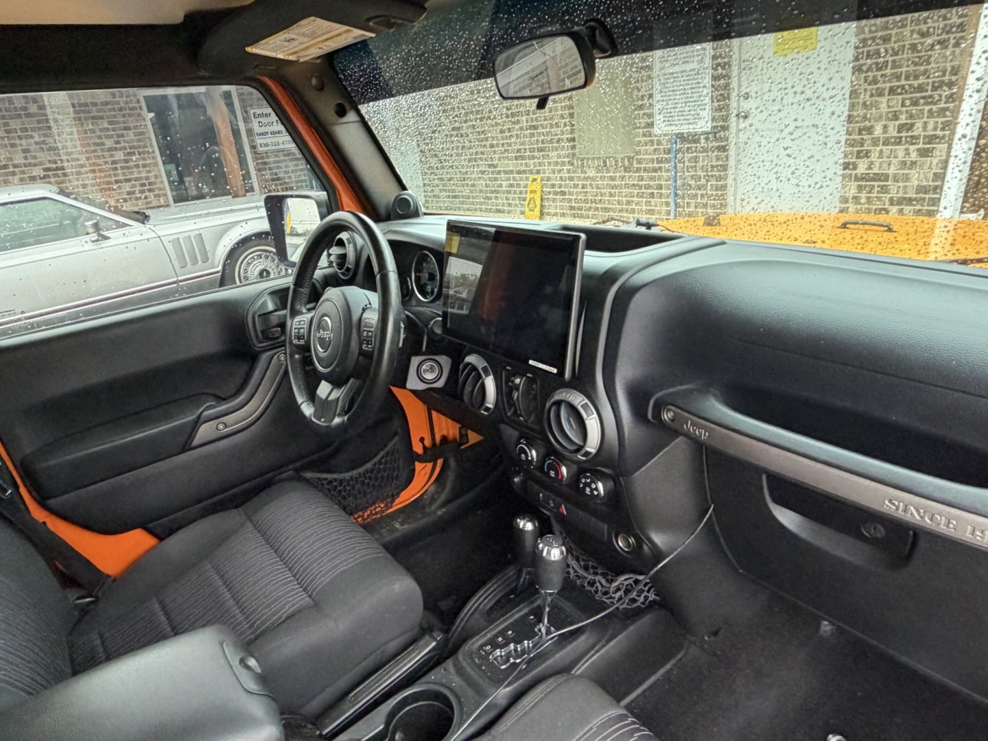 2012 Orange Jeep Wrangler Unlimited Sport 4WD (1C4BJWDGXCL) with an 3.6L V6 DOHC 24V FFV engine, located at 1687 Business 35 S, New Braunfels, TX, 78130, (830) 625-7159, 29.655487, -98.051491- Photo#3