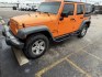 2012 Orange Jeep Wrangler Unlimited Sport 4WD (1C4BJWDGXCL) with an 3.6L V6 DOHC 24V FFV engine, located at 1687 Business 35 S, New Braunfels, TX, 78130, (830) 625-7159, 29.655487, -98.051491- Photo#0