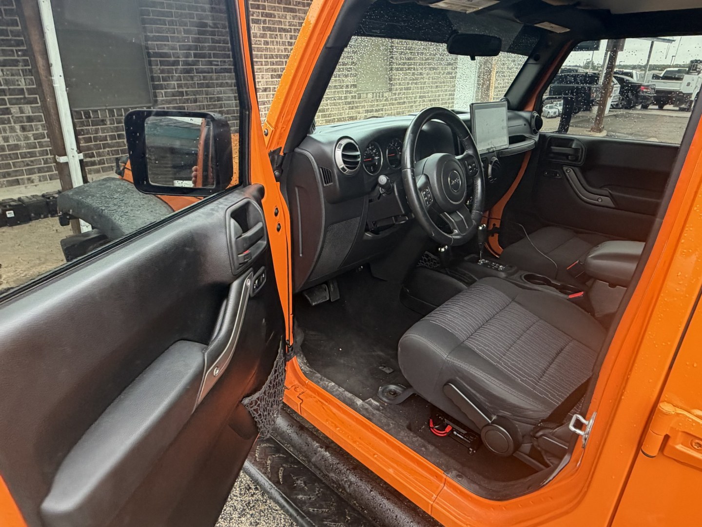 2012 Orange Jeep Wrangler Unlimited Sport 4WD (1C4BJWDGXCL) with an 3.6L V6 DOHC 24V FFV engine, located at 1687 Business 35 S, New Braunfels, TX, 78130, (830) 625-7159, 29.655487, -98.051491- Photo#9