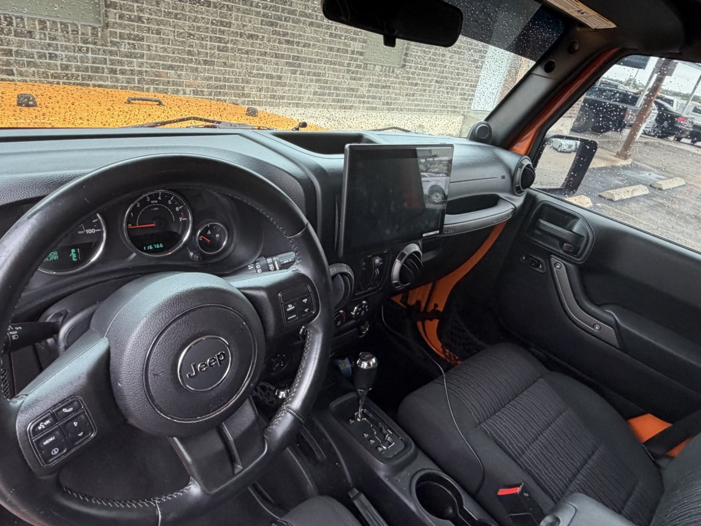 2012 Orange Jeep Wrangler Unlimited Sport 4WD (1C4BJWDGXCL) with an 3.6L V6 DOHC 24V FFV engine, located at 1687 Business 35 S, New Braunfels, TX, 78130, (830) 625-7159, 29.655487, -98.051491- Photo#11